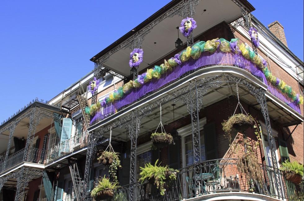 Typical French Quarter wrought iron balconies in preparation for Mardi Gras.