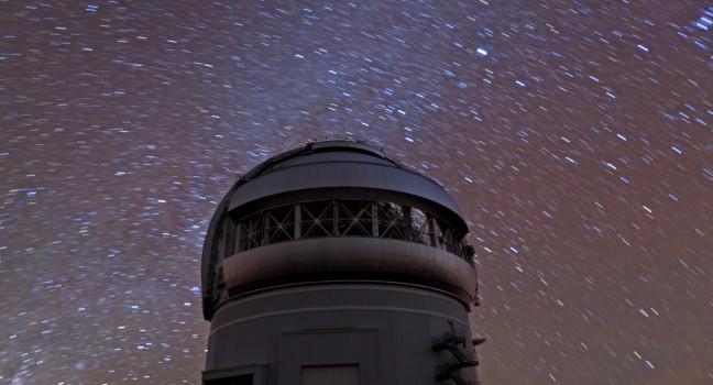 Star observatory in Hawaii at night with Milky Way.