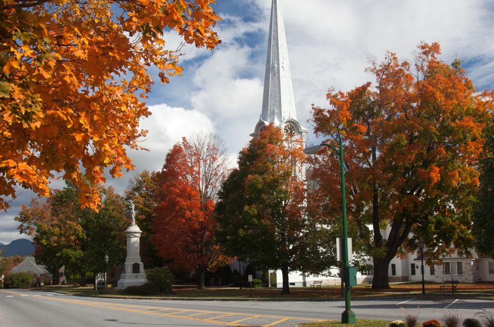 Autumnal shot of the main street of Manchester Vermont in fall as the bright trees turn orange and red