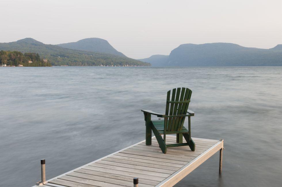 An adirondack chair on a dock at Lake Willoughby, Vermont, USA