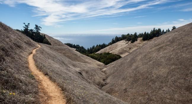 A hiking trail on Mount Tamalpais just north of San Francisco, California, in Marin, leads westward.  This area has many hiking trails used for recreation and is just above Stinson Beach.;