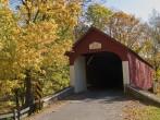An Autumn view of the historic Knechts Covered Bridge in rural Bucks County, Pennsylvania.