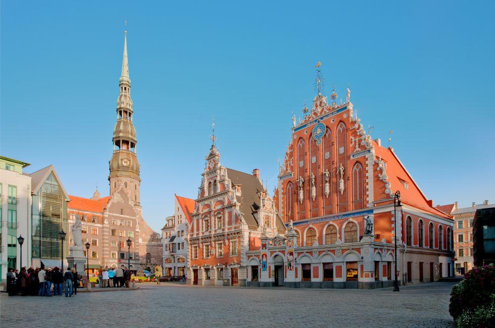 Old town square in the center of Riga, Latvia. Tourist attractions House of Blackheads and St Peters church.; 